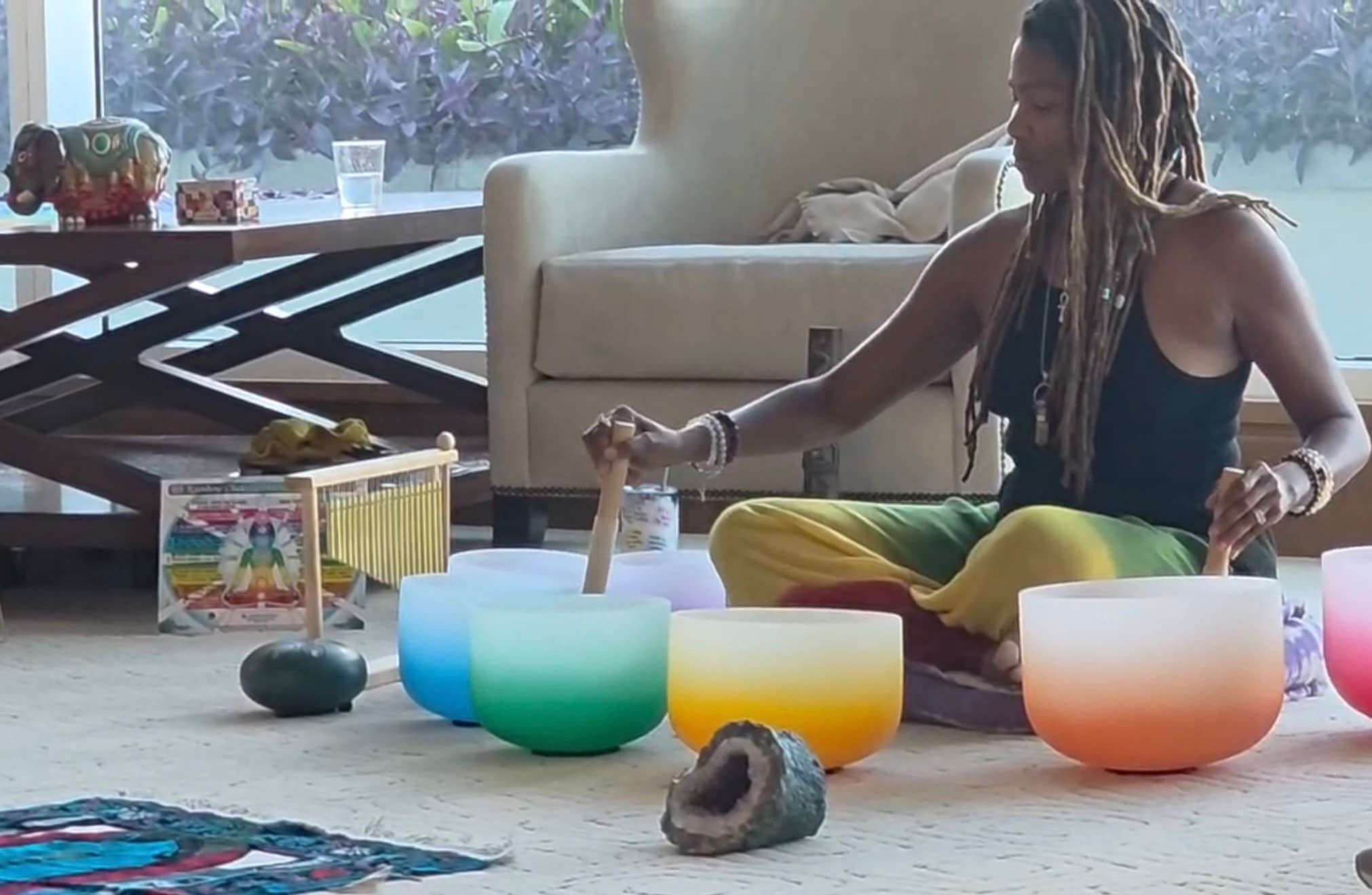 Malinda playing a set of chakra-tuned crystal singing bowls